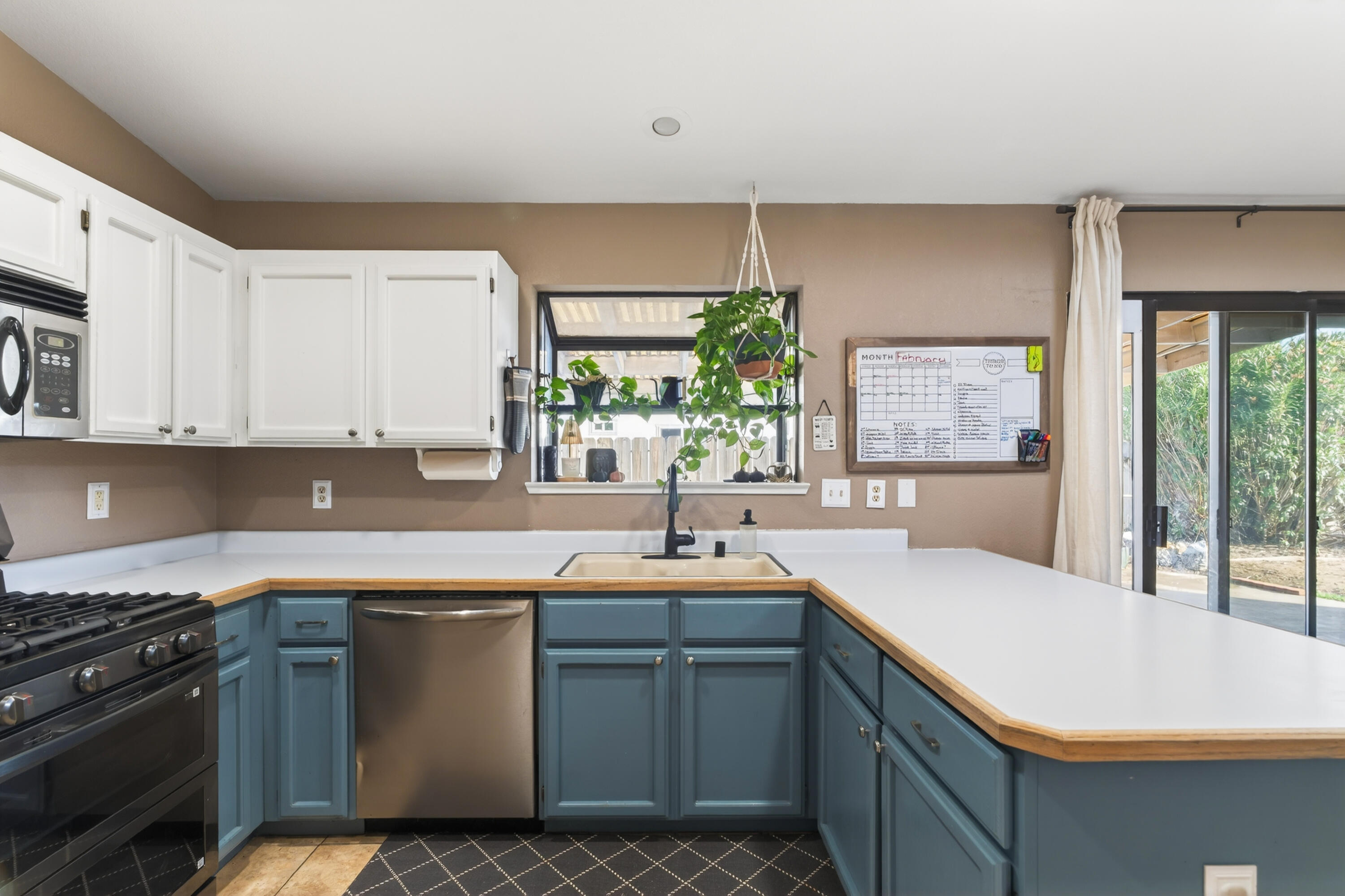 3733 Capricorn Way Redding, CA 96002 - Photo 4 of 22 a kitchen with a sink and cabinets