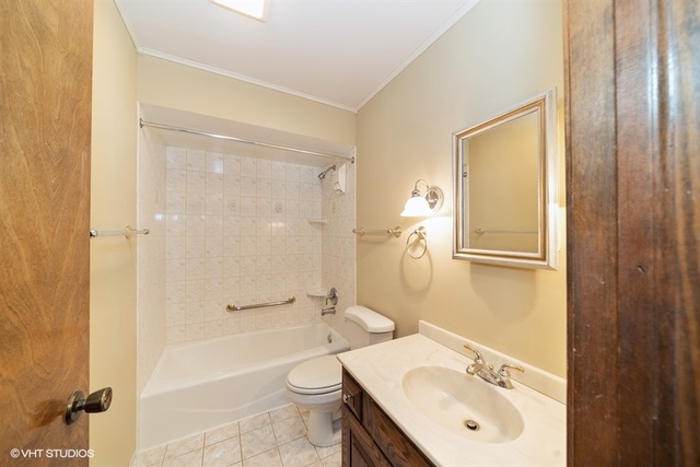11S452 Book Road Naperville, IL 60564 - Photo 3 of 25 a bathroom with a sink a toilet and shower