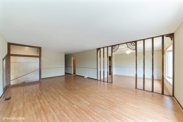 11S452 Book Road Naperville, IL 60564 - Photo 23 of 25 a view of an empty room with wooden floor and a window