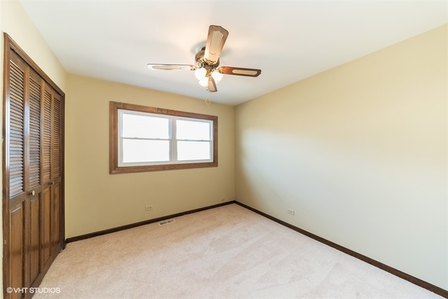 11S452 Book Road Naperville, IL 60564 - Photo 4 of 25 an empty room with windows and fan