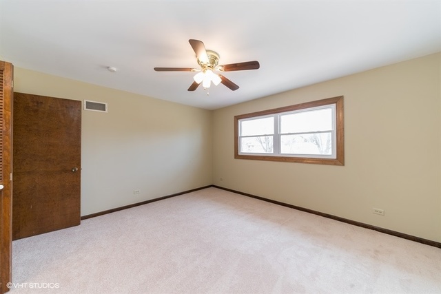 11S452 Book Road Naperville, IL 60564 - Photo 7 of 25 a view of an empty room with a window