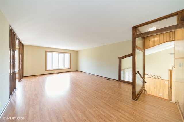 11S452 Book Road Naperville, IL 60564 - Photo 9 of 25 a view of an empty room with glass door and wooden floor