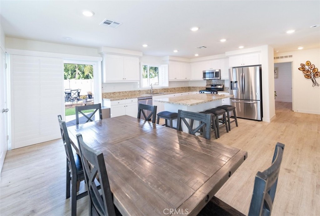 32078 Rambling Court Winchester, CA 92596 - Photo 14 of 48 a living room with stainless steel appliances furniture dining table and wooden floor