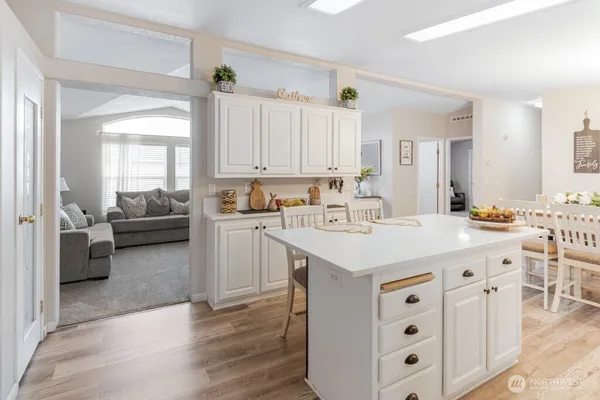 a kitchen with a sink a stove and cabinets