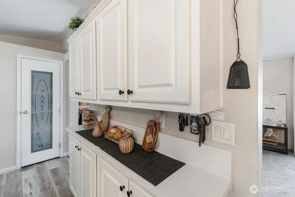 a kitchen with stainless steel appliances a white stove top oven and a white cabinets