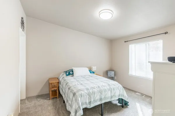 a bedroom with a bed and a window