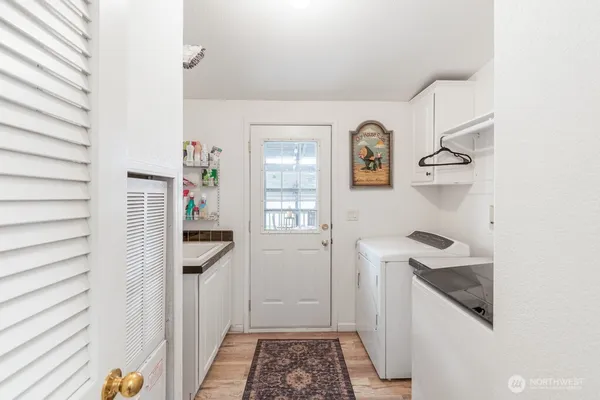 a kitchen with a refrigerator and white cabinets
