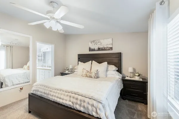 a bedroom with a large bed and a chandelier