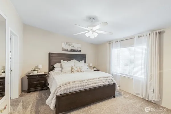a bedroom with a large bed and a chandelier