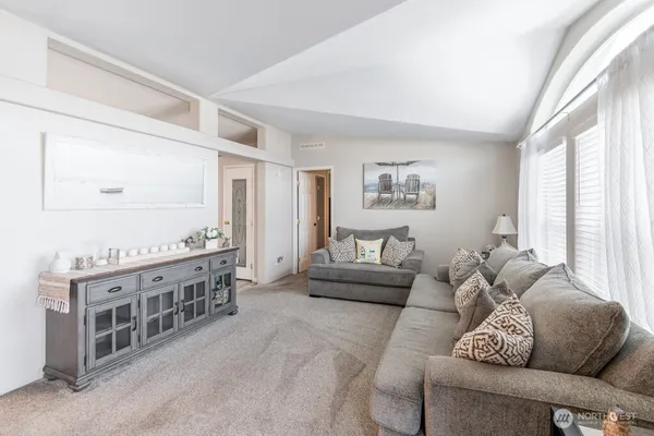 a living room with furniture cabinets and a window