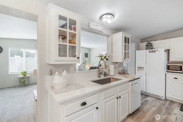 a kitchen with sink refrigerator and window
