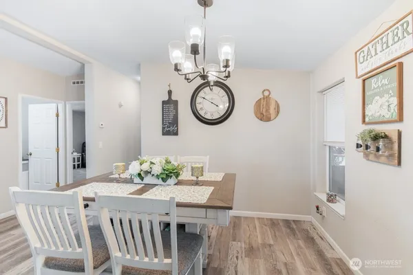 a view of a dining area with furniture wooden floor and a chandelier