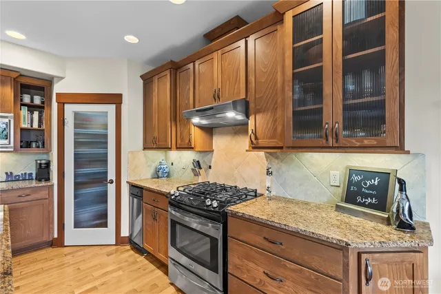 a kitchen with granite countertop a stove and a refrigerator