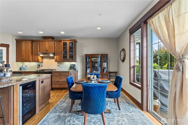 a kitchen with stainless steel appliances granite countertop sink stove top oven and cabinets