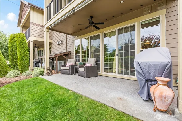 a view of a porch with furniture and a yard