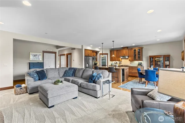 a living room with furniture and view of kitchen