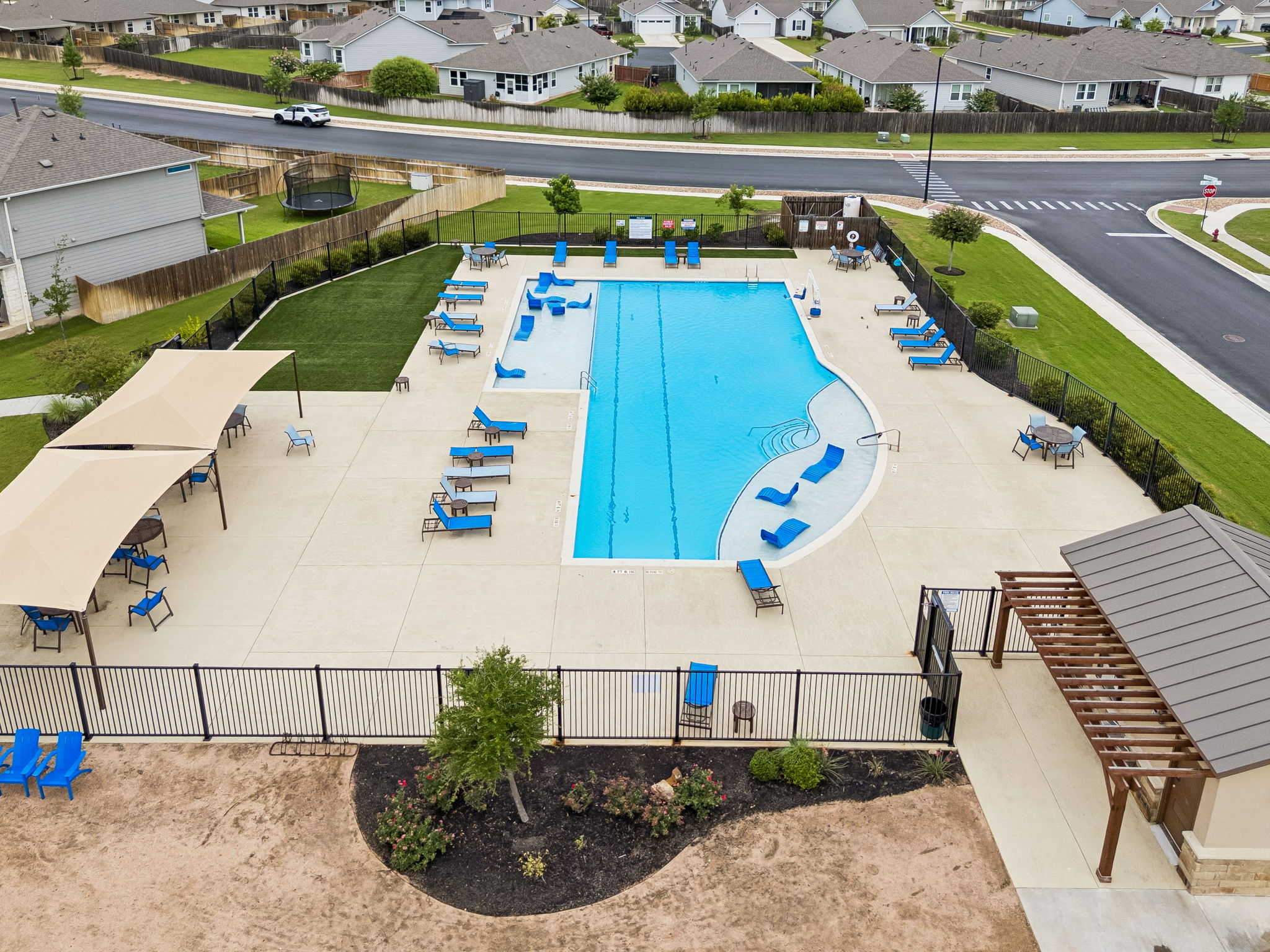 301 Rimrock Court Bastrop, TX 78602 - Photo 20 of 21 An inviting community pool with ample lounge seating awaits, perfect for relaxation.