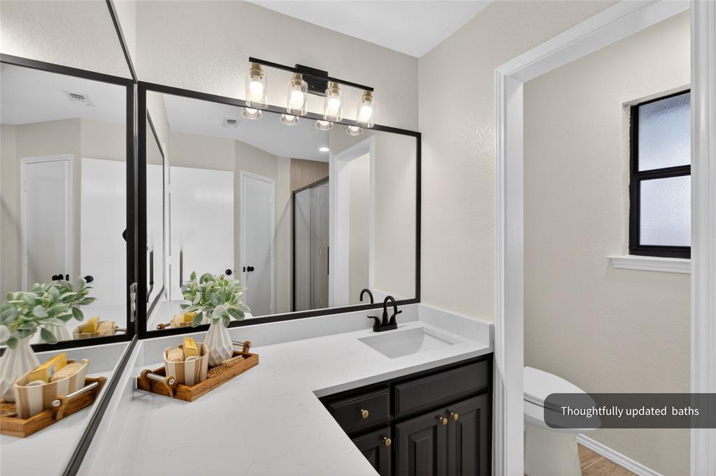 509 Brookside Court Burleson, TX 76028 - Photo 9 of 18 a bathroom with a sink and a mirror