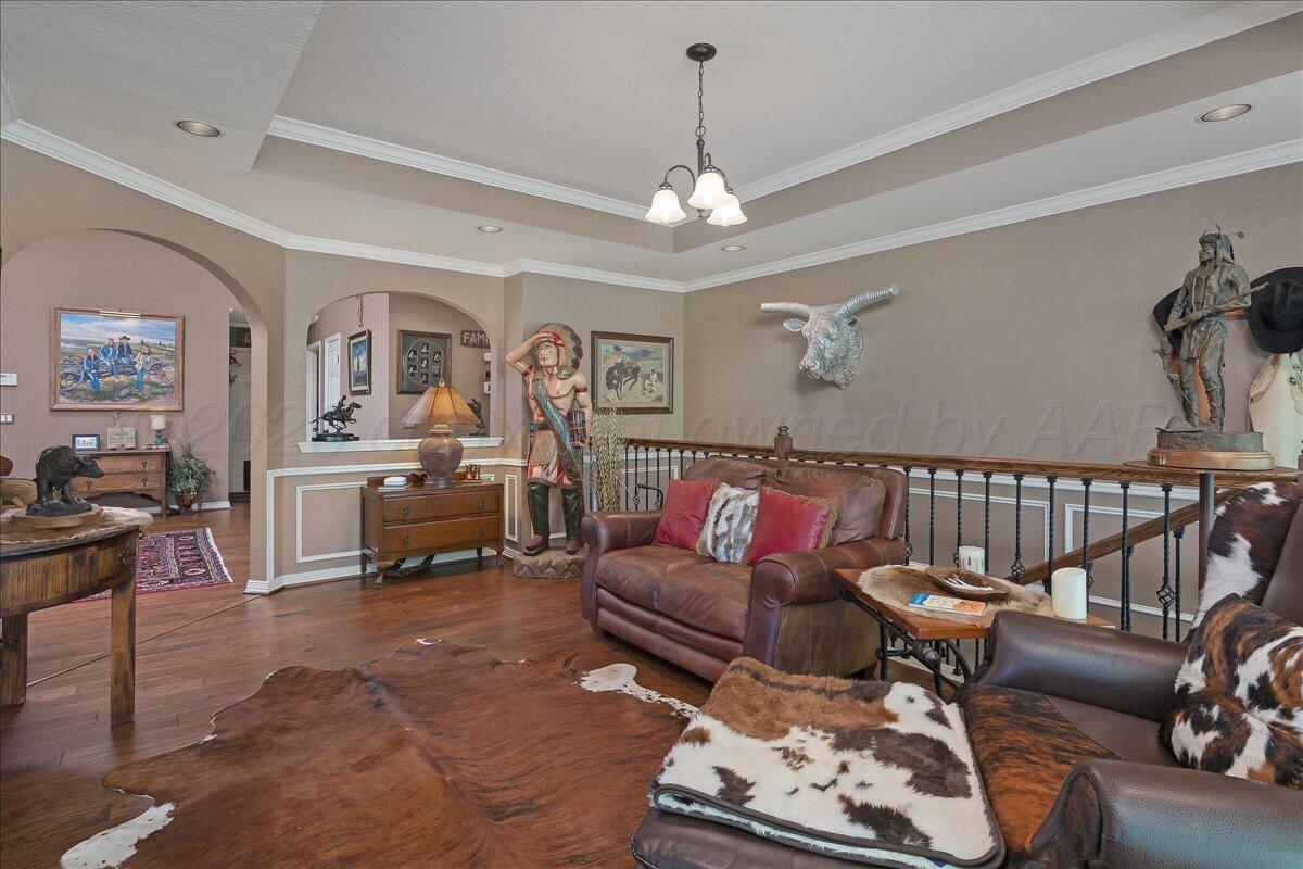 5 Locke Place Amarillo, TX 79124 - Photo 16 of 53 a living room with furniture a rug and a chandelier