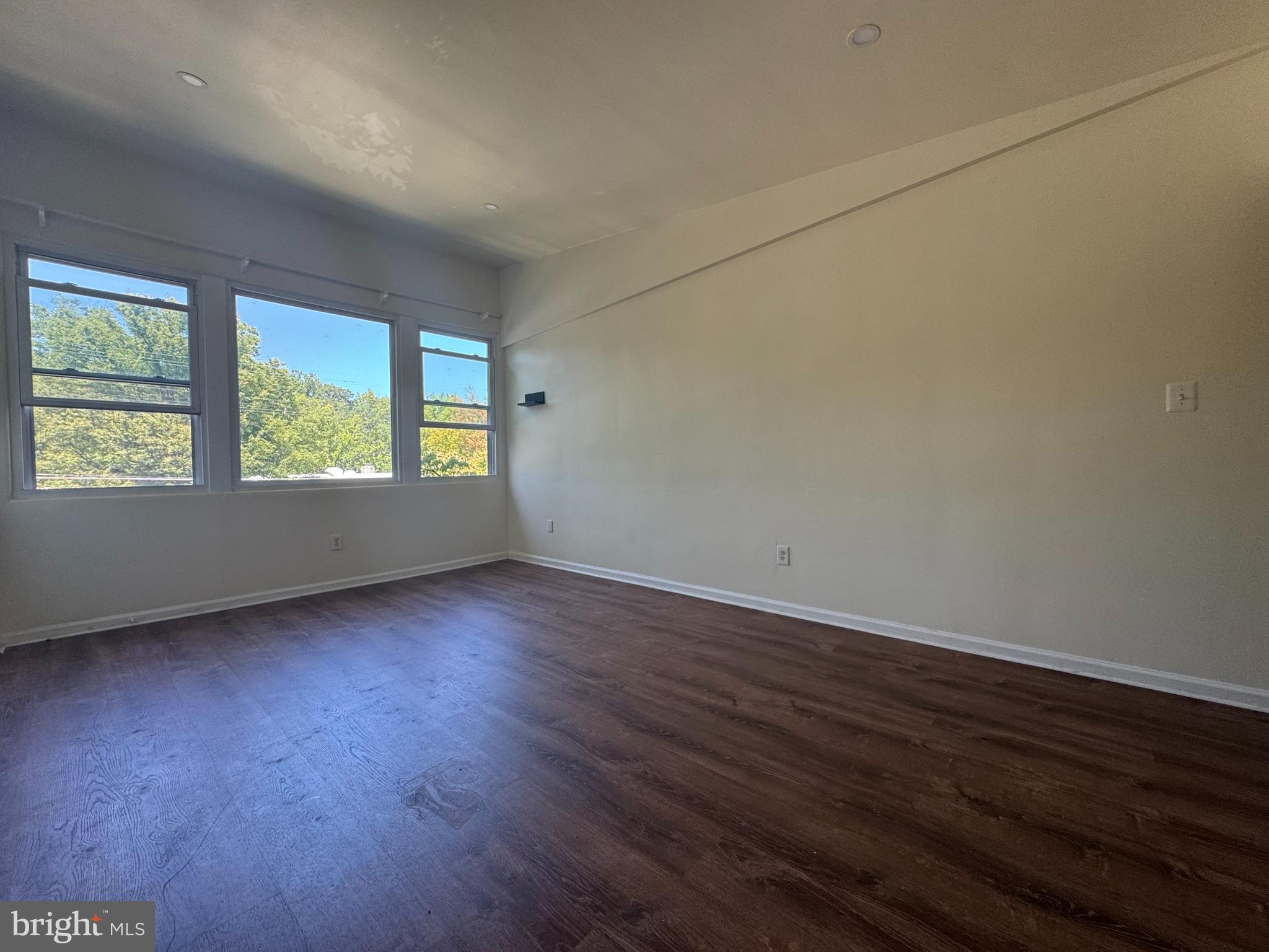 1015 Quebec Terrace Silver Spring, MD 20903 - Photo 7 of 13 an empty room with wooden floor and windows