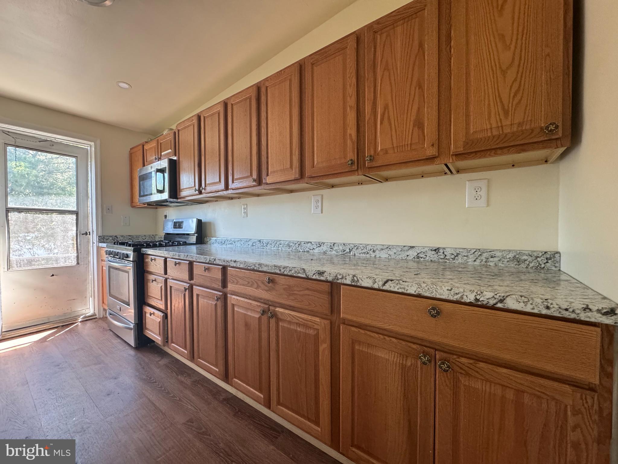 1015 Quebec Terrace Silver Spring, MD 20903 - Photo 9 of 13 a kitchen with stainless steel appliances granite countertop a sink stove and cabinets