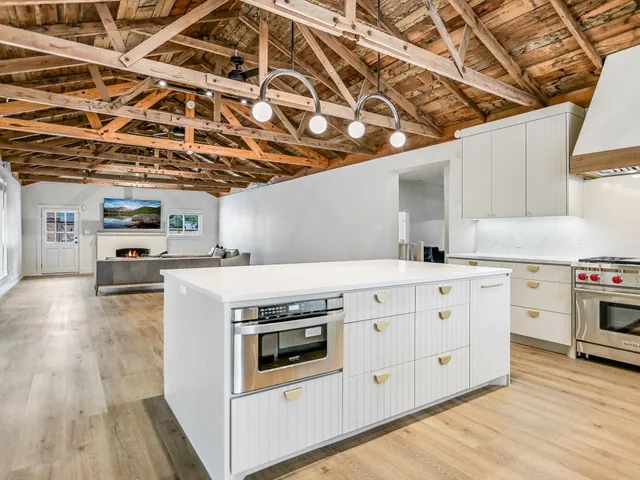 a kitchen with stove and cabinets
