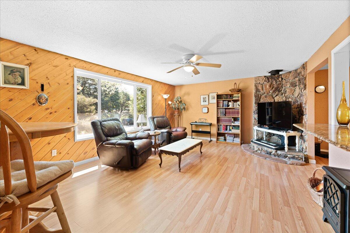 4093 Old Upton Road Central Point, OR 97502 - Photo 20 of 23 a living room with furniture a flat screen tv and a floor to ceiling window