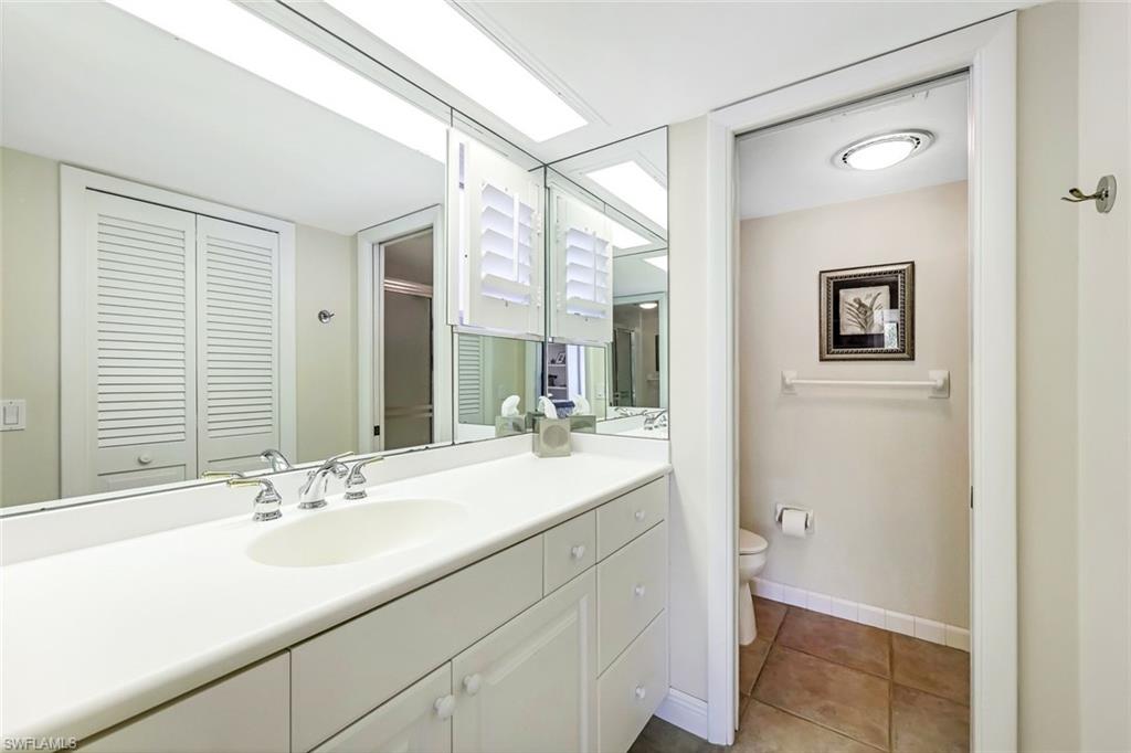 2216 Gulf Shore Boulevard North, Unit R3 Naples, FL 34102 - Photo 12 of 16 a bathroom with a sink and a mirror