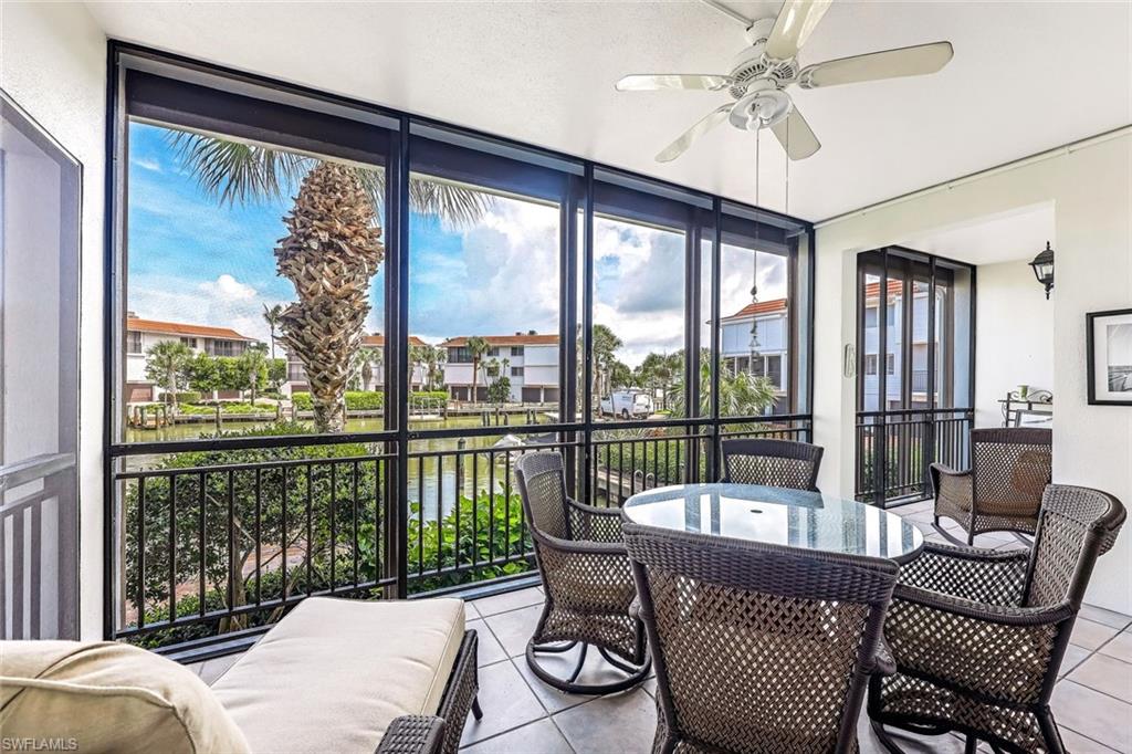 2216 Gulf Shore Boulevard North, Unit R3 Naples, FL 34102 - Photo 15 of 16 a living room with furniture and a floor to ceiling window