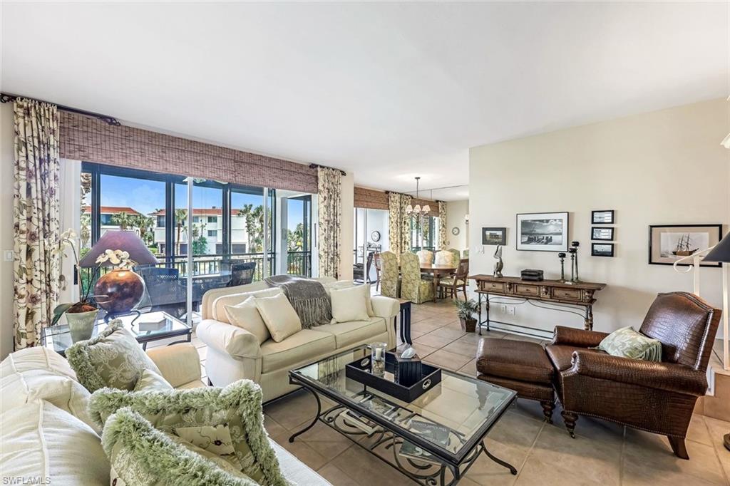 2216 Gulf Shore Boulevard North, Unit R3 Naples, FL 34102 - Photo 2 of 16 a living room with furniture and a large window