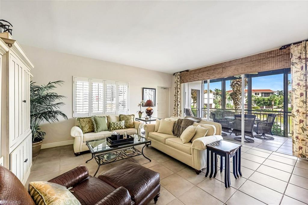 2216 Gulf Shore Boulevard North, Unit R3 Naples, FL 34102 - Photo 3 of 16 a living room with furniture and a large window