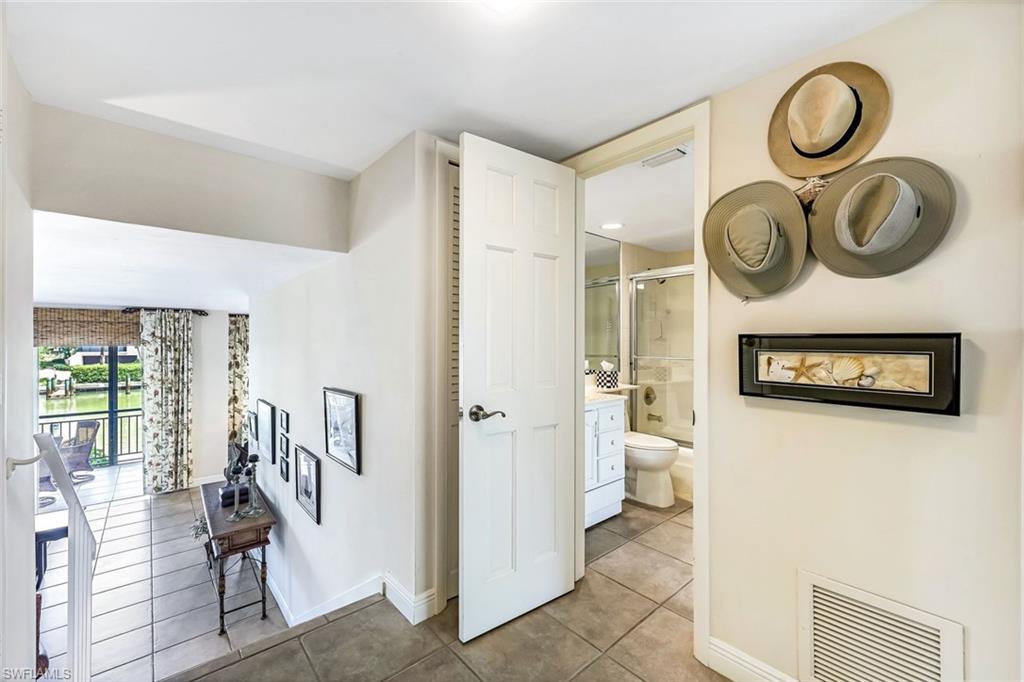 2216 Gulf Shore Boulevard North, Unit R3 Naples, FL 34102 - Photo 5 of 16 a view of a hallway with bathroom and wooden floor