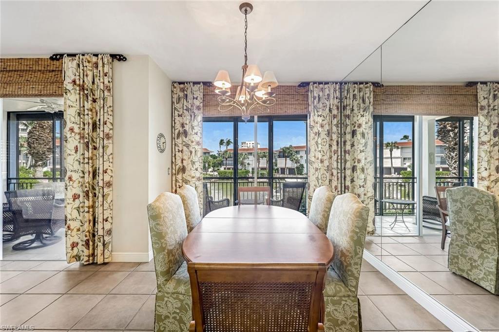 2216 Gulf Shore Boulevard North, Unit R3 Naples, FL 34102 - Photo 6 of 16 a view of a dining room with furniture window and outside view