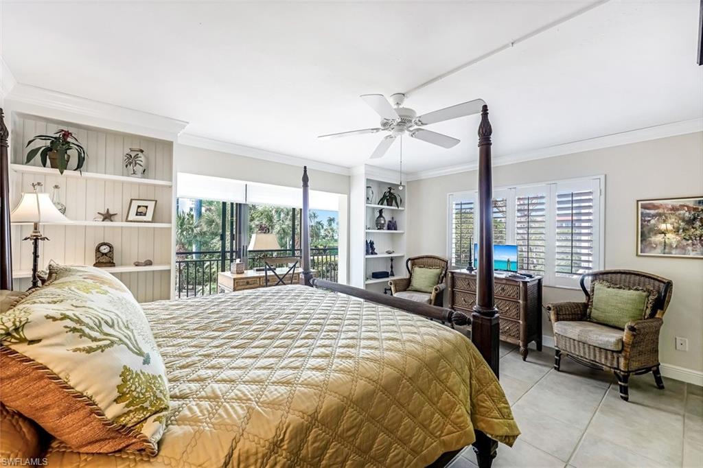 2216 Gulf Shore Boulevard North, Unit R3 Naples, FL 34102 - Photo 10 of 16 a bedroom with a bed and large windows