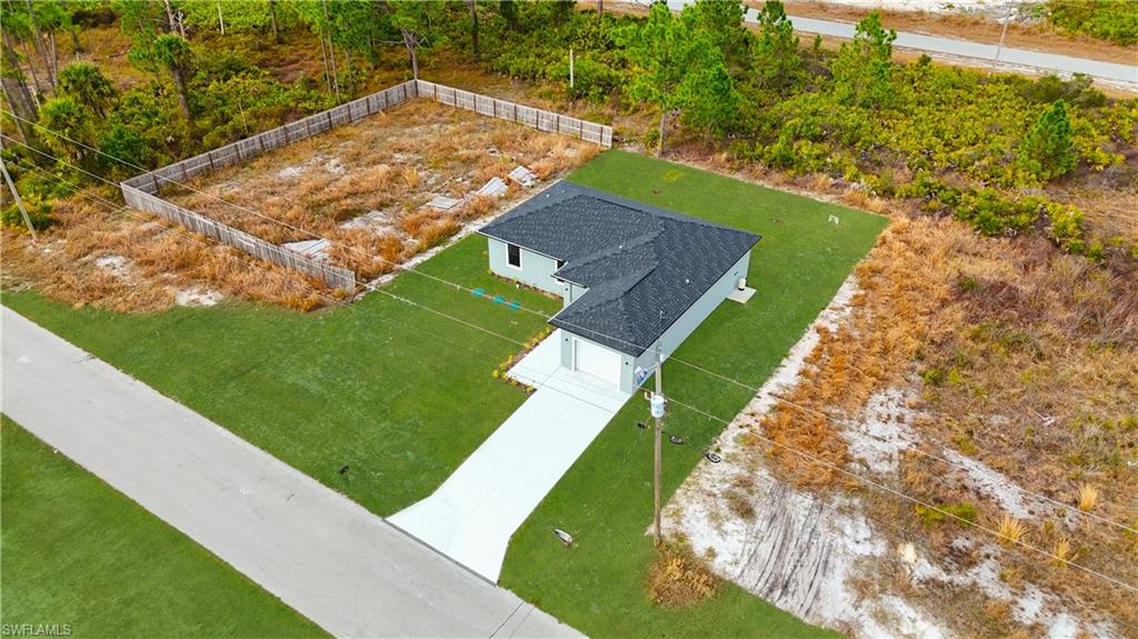 1217 Cellini Street East Lehigh Acres, FL 33974 - Photo 2 of 23 a view of a backyard with lawn chairs