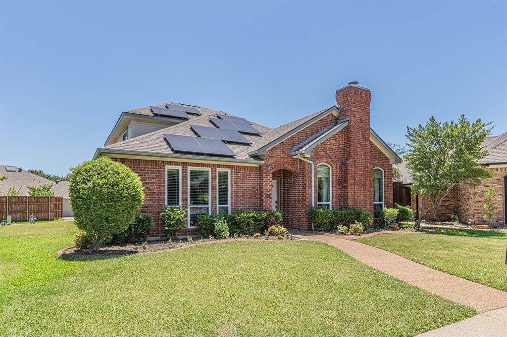 300 Sundance Circle Irving, TX 75063 - Photo 2 of 39 Red brick exterior with a prominent chimney feature, accented by arched and rectangular windows