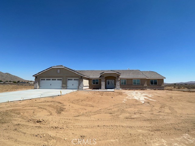 21180 South Road Apple Valley, CA 92307 - Photo 1 of 1 a front view of a house with a yard