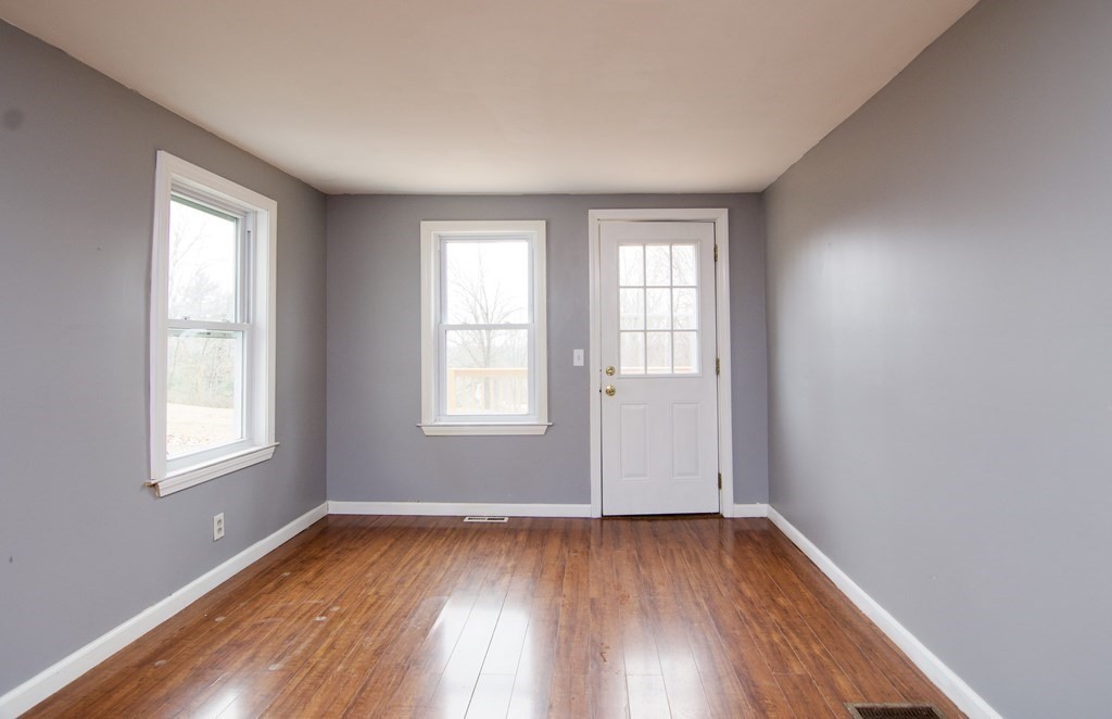 338 Wilbraham Road Hampden, MA 01036 - Photo 15 of 42 an empty room with wooden floor and windows