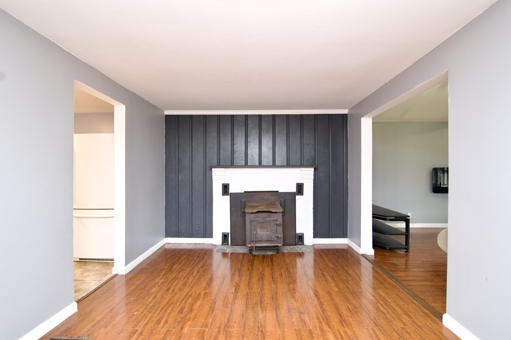 338 Wilbraham Road Hampden, MA 01036 - Photo 17 of 42 a view of empty room with wooden floor and fireplace