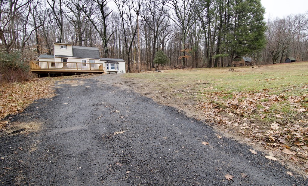 338 Wilbraham Road Hampden, MA 01036 - Photo 2 of 42 a view of a yard with a house and trees