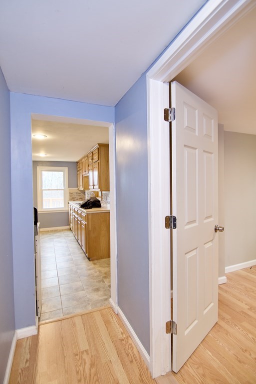 338 Wilbraham Road Hampden, MA 01036 - Photo 26 of 42 a view of a hallway with wooden floor and a living room