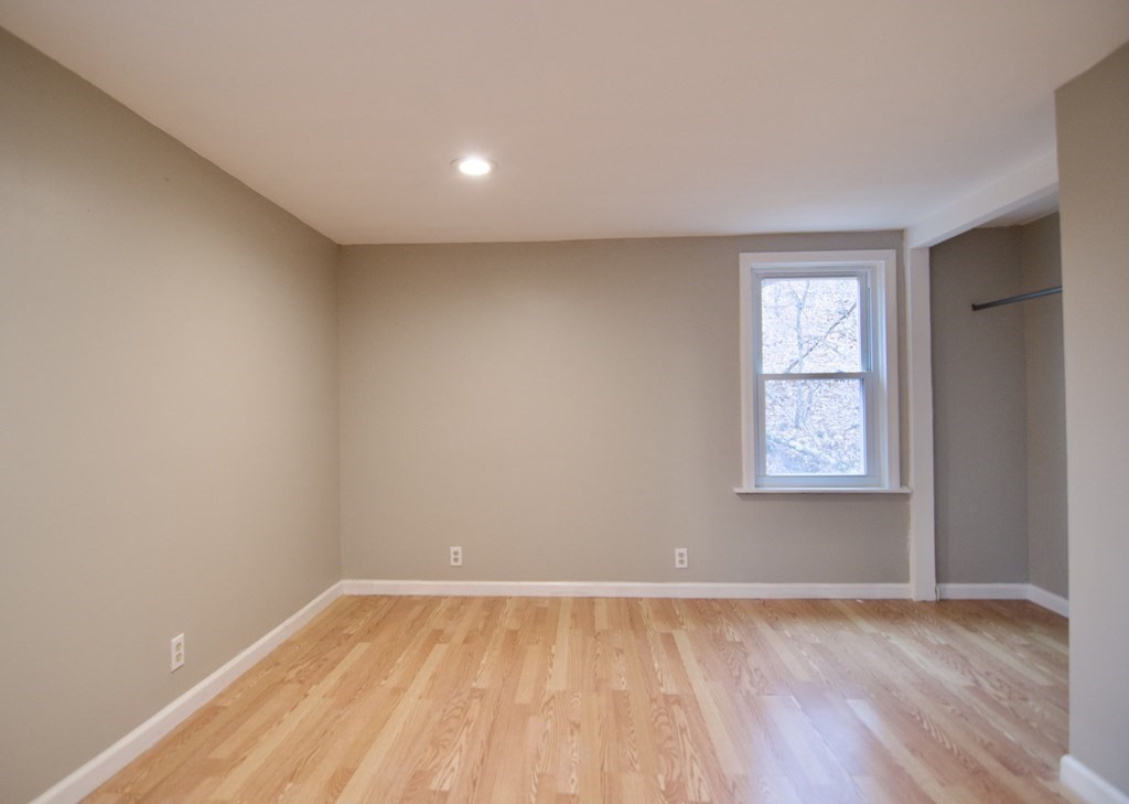 338 Wilbraham Road Hampden, MA 01036 - Photo 28 of 42 an empty room with wooden floor and windows