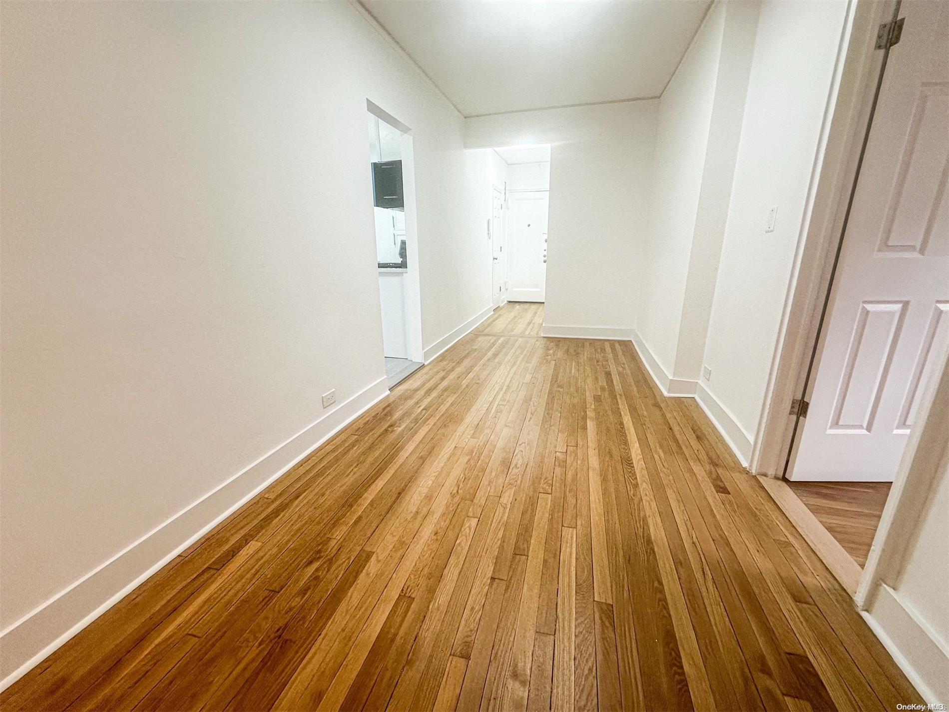 110-34 73rd Road, Unit 4C Queens, NY 11375 - Photo 5 of 10 a view of wooden floor in a room