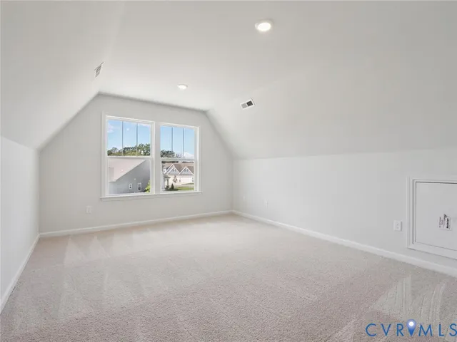 an empty room with entrance and windows