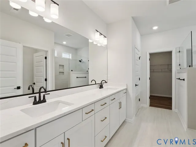a spacious bathroom with double sink and a large mirror
