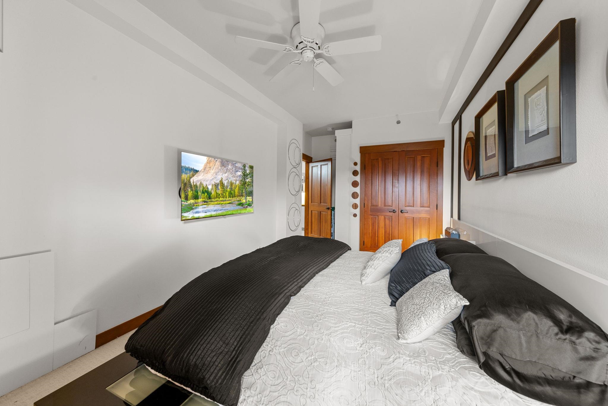 1750 Village East Road, Unit 409 (5409) Olympic Valley, CA 96146 - Photo 11 of 27 a bedroom with a bed and a painting on the wall