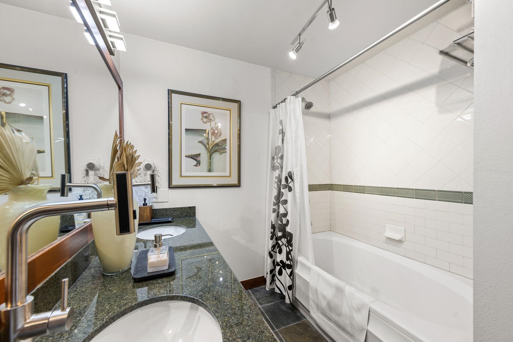 1750 Village East Road, Unit 409 (5409) Olympic Valley, CA 96146 - Photo 12 of 27 a bathroom with a granite countertop sink a toilet and a bathtub