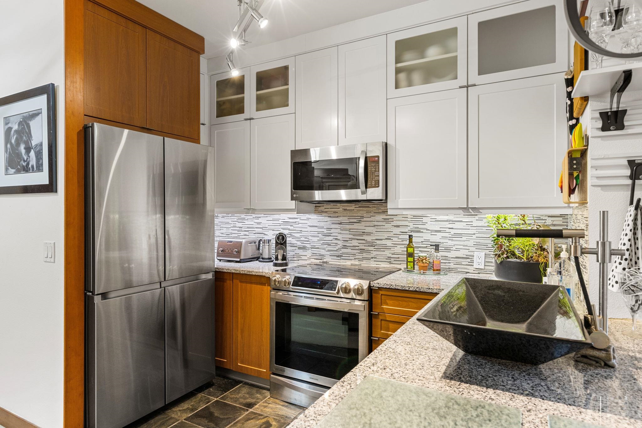 1750 Village East Road, Unit 409 (5409) Olympic Valley, CA 96146 - Photo 4 of 27 a kitchen with stainless steel appliances granite countertop a refrigerator a stove and a sink with wooden floor