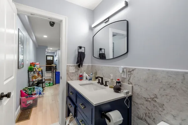 a bathroom with a sink vanity and a mirror