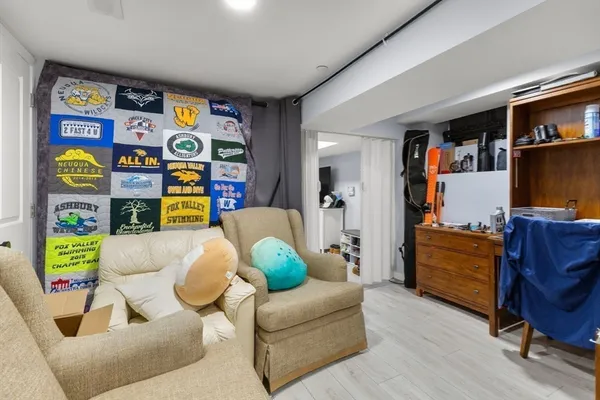 a living room with furniture and a book shelf